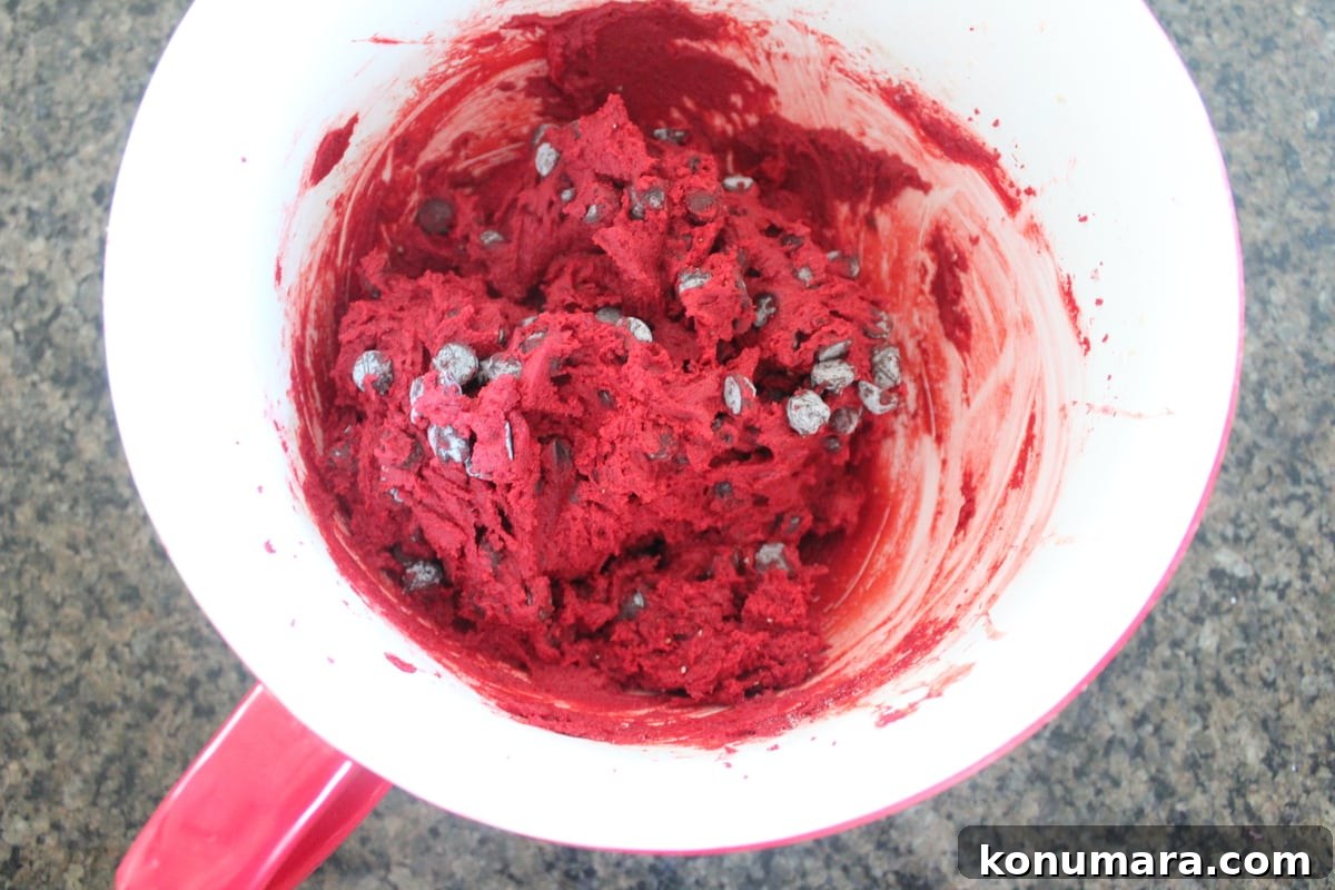 Red velvet chocolate chip cookie dough mixed in a bowl.