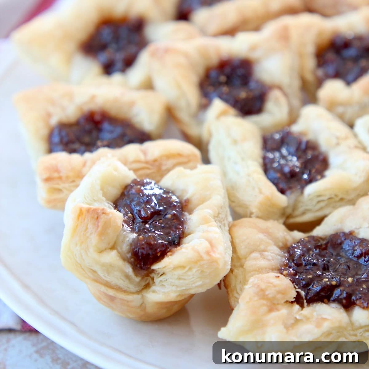 Fig jam and brie in baked puff pastry bites on plate