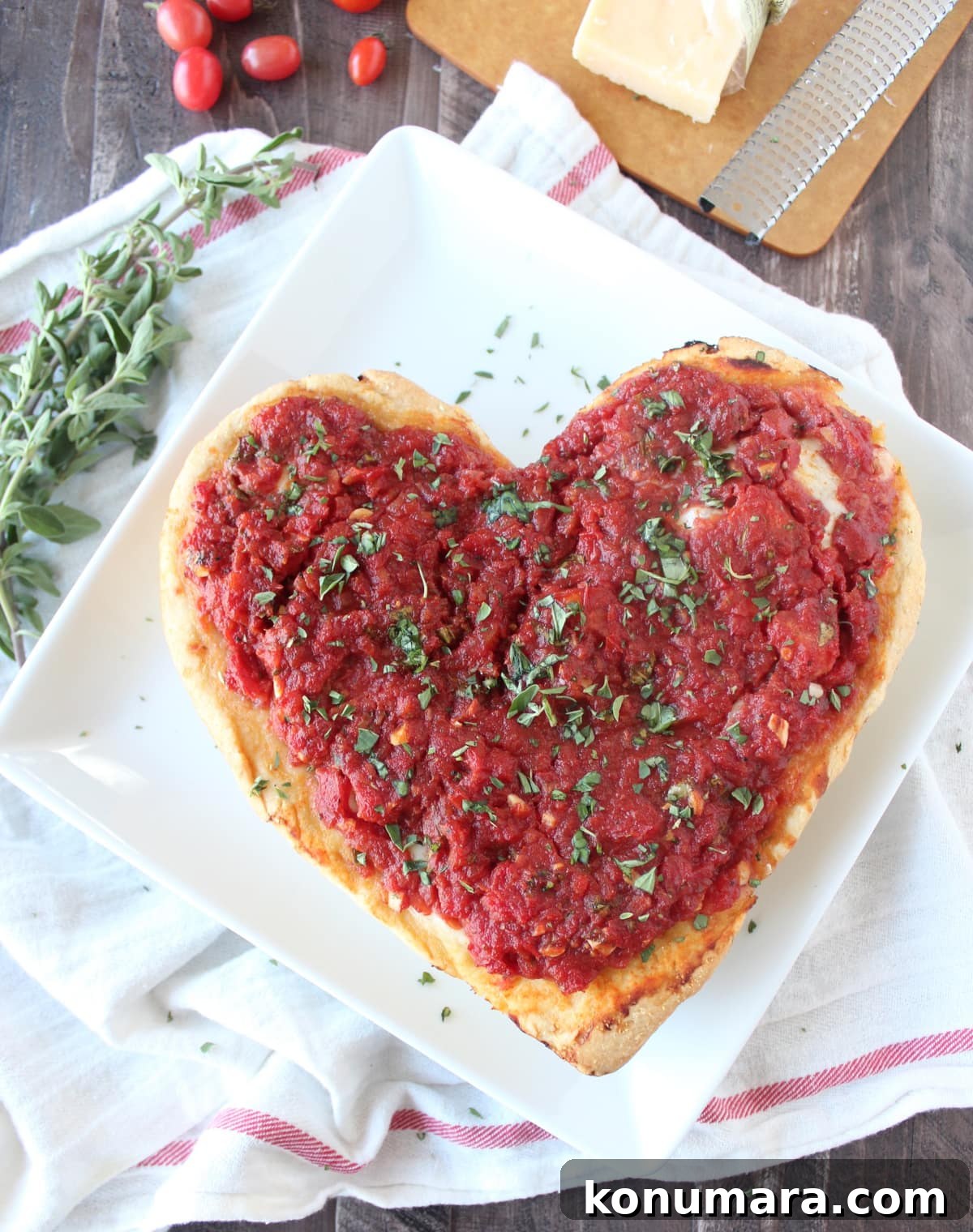 Heart-Shaped Pizza Recipe for Date Night 2 Heart Shaped Pizza on a white plate.