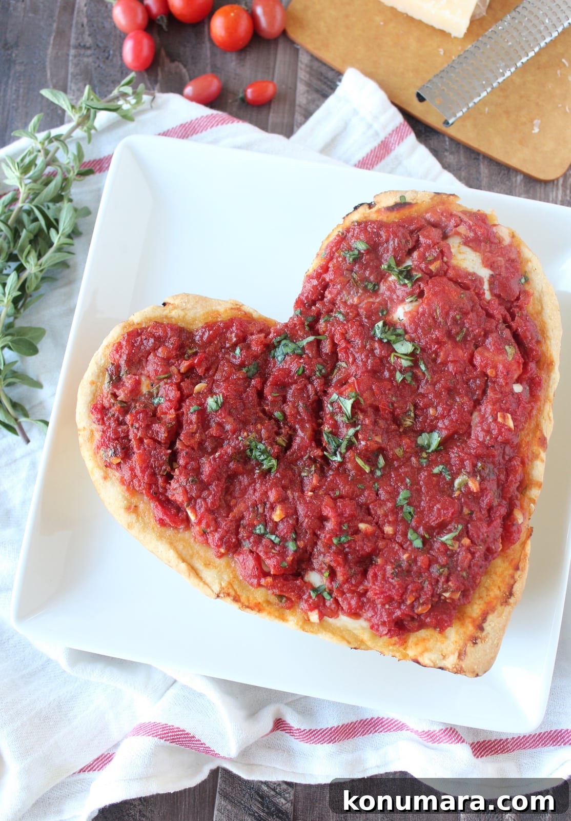 Heart-Shaped Pizza Recipe for Date Night 10 Heart Shaped Pizza on a white plate.