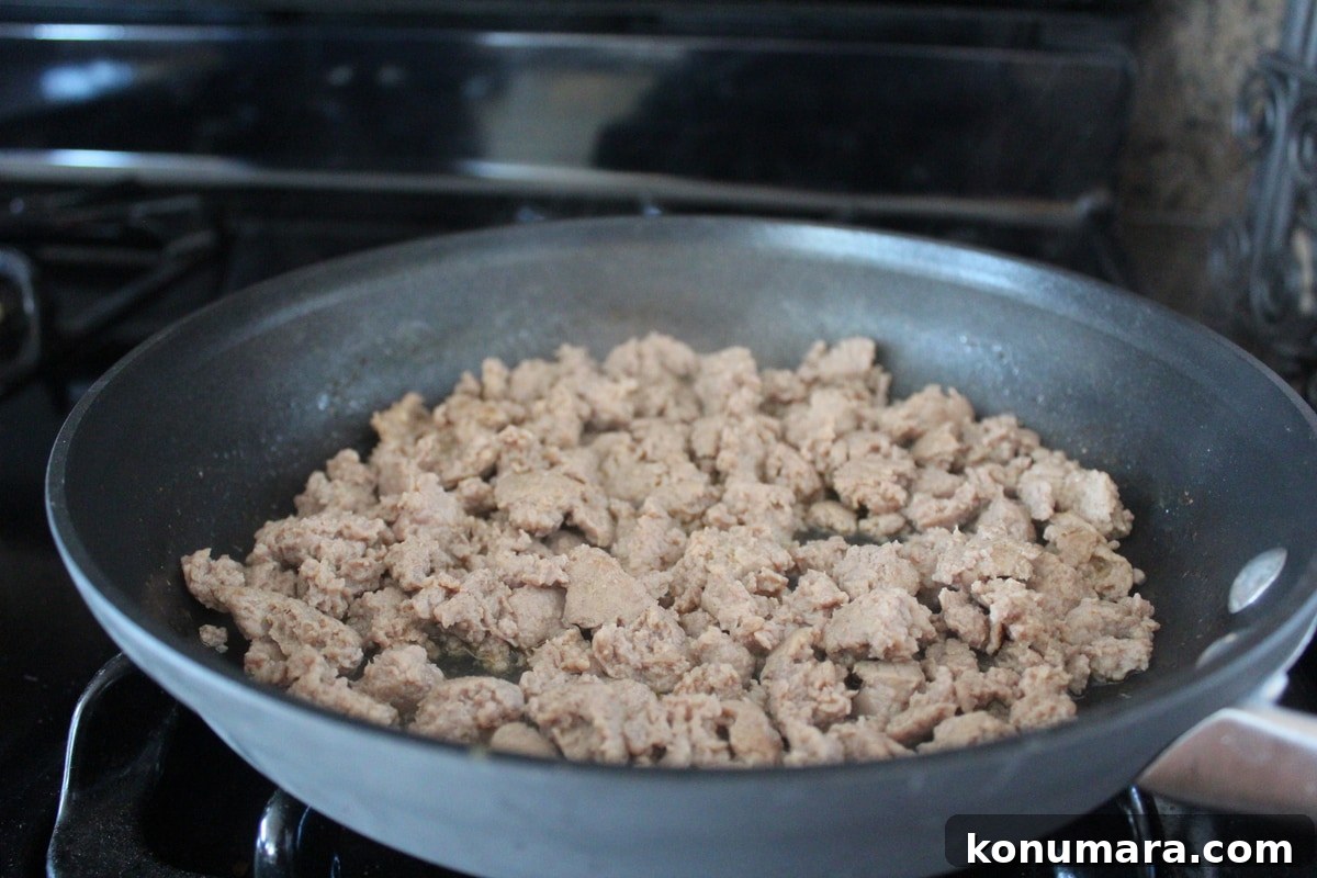 Heart-Shaped Pizza Recipe for Date Night 4 Ground pork cooking in a skillet.