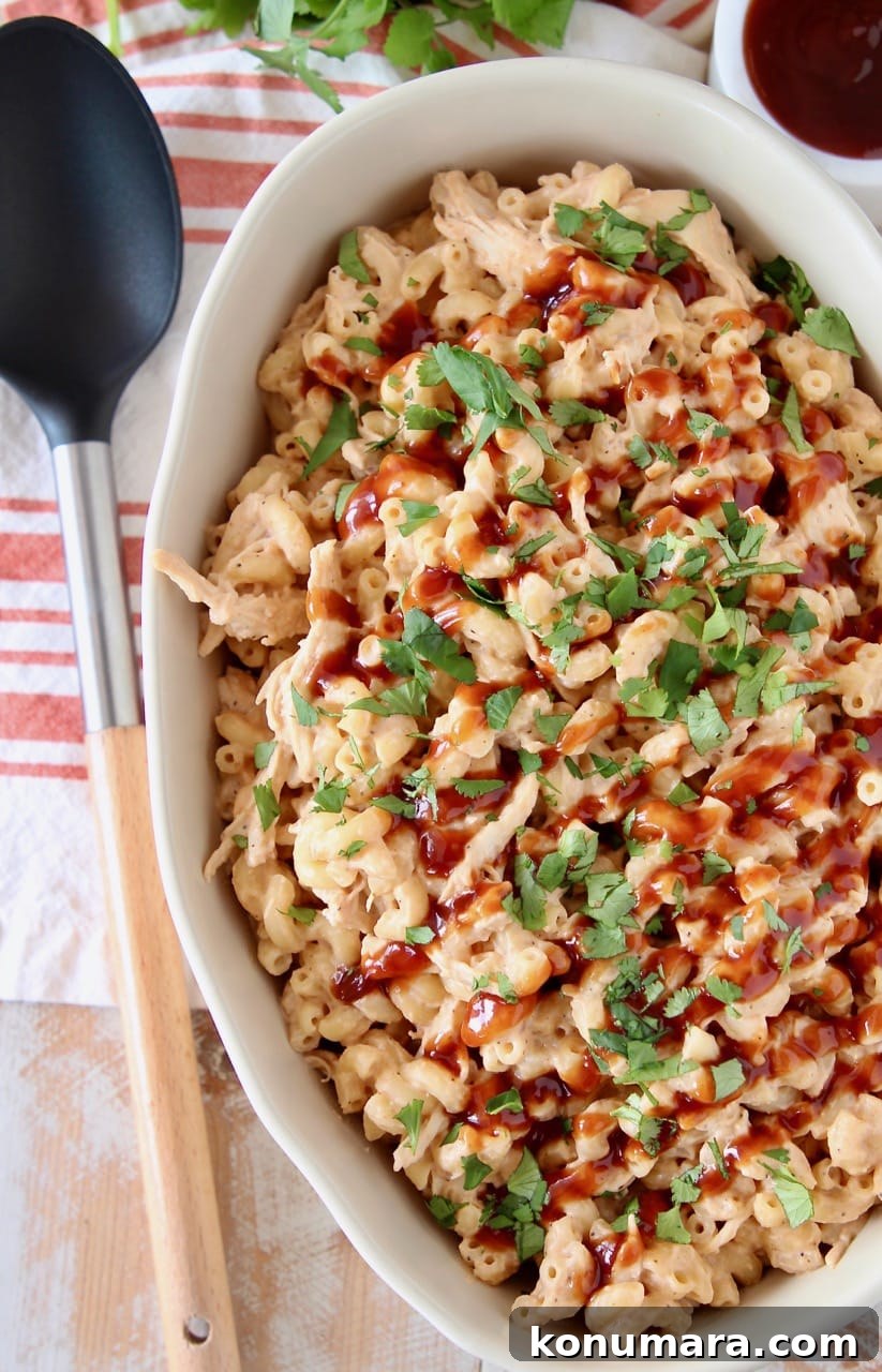 Smoky BBQ Chicken Mac and Cheese Recipe 2 BBQ Chicken mac and cheese in large oval casserole dish topped with fresh chopped cilantro