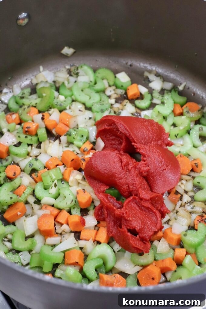 Authentic Slow Simmered Pork Ragu Recipe 6 diced vegetables in pot with tomato paste