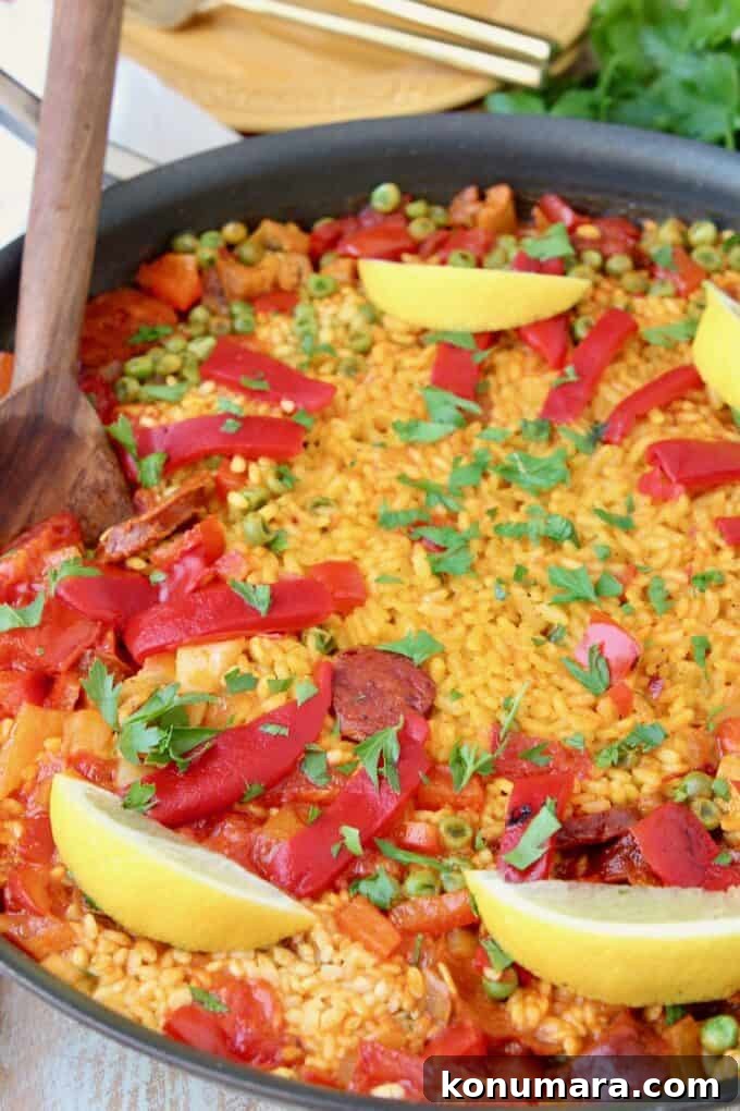 Authentic Spanish Chorizo and Chicken Paella Recipe 7 Pan of spanish paella topped with lemon wedges