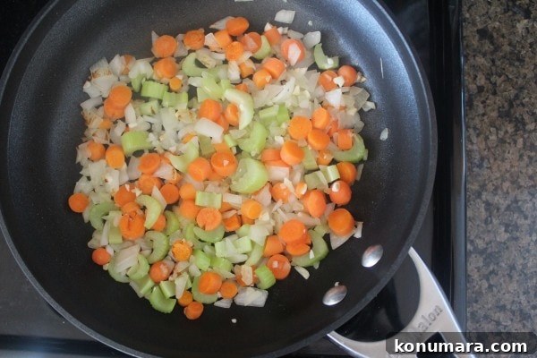 Spicy Buffalo Chicken Meatloaf with Blue Cheese 4 diced carrots, onions and celery in skillet on stove