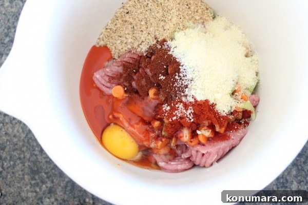 Spicy Buffalo Chicken Meatloaf with Blue Cheese 5 ground chicken and pork in large bowl with egg, breadcrumbs and spices