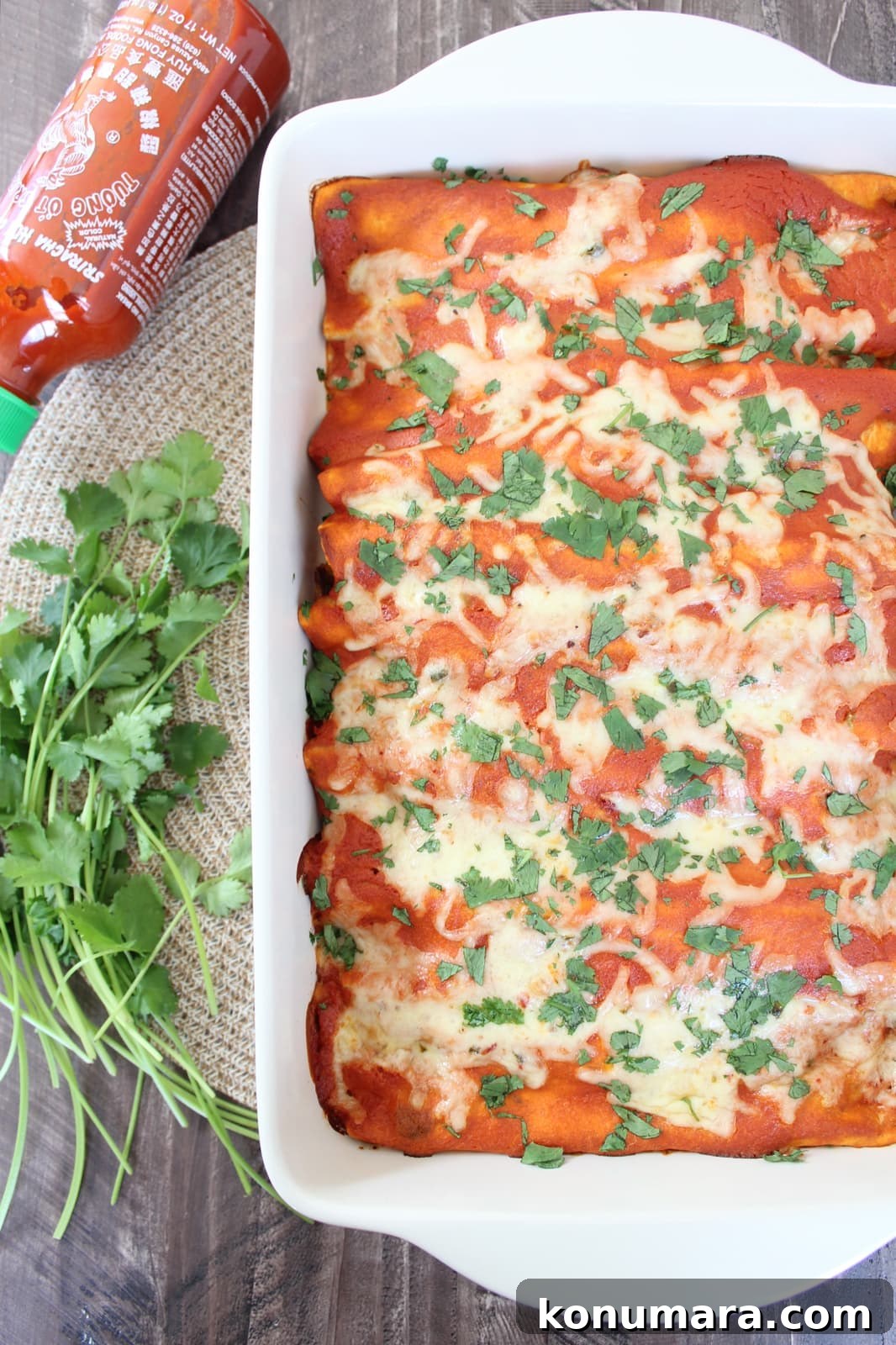 enchiladas in a baking dish with fresh cilantro
