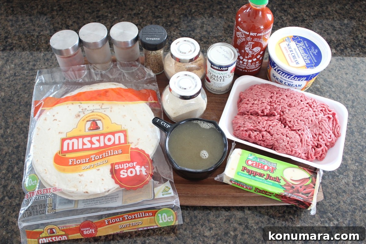 Creamy Sriracha Beef Enchilada Recipe Ingredients on a wood board