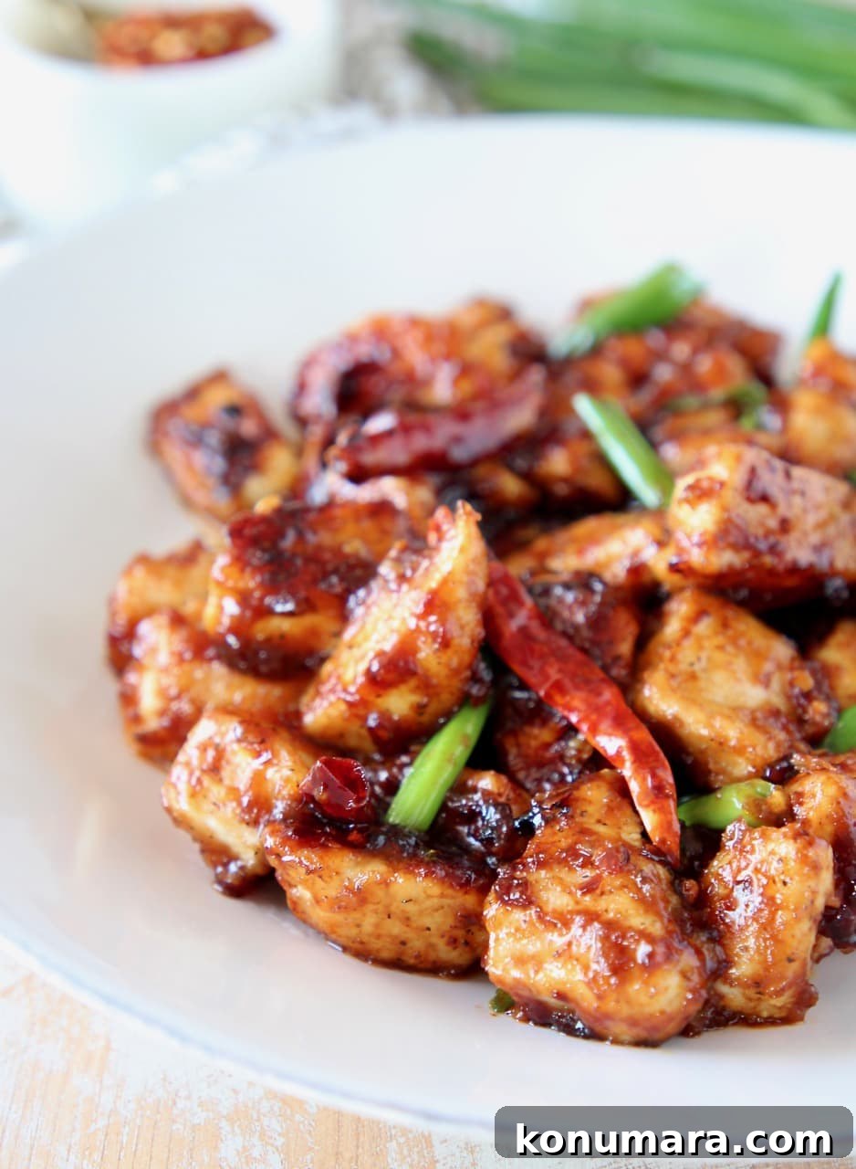 Gluten-Free General Tso's Chicken Recipe 4 General tso chicken on plate with red chilies and scallions