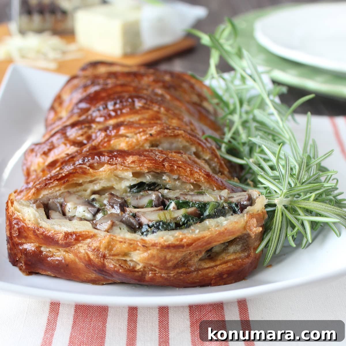 baked braided puff pastry on plate with fresh rosemary