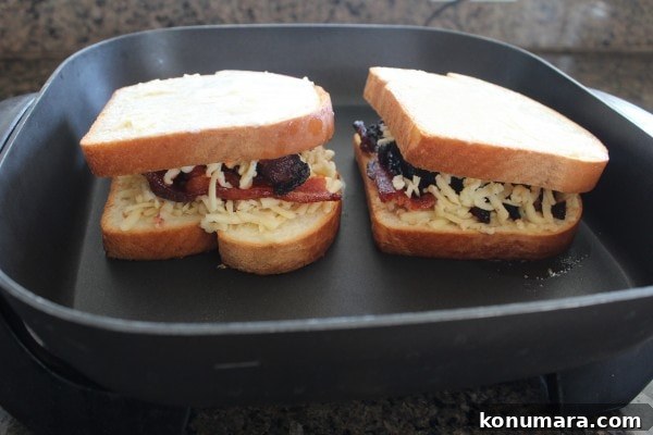 bacon grilled cheese sandwiches cooking in an electric skillet