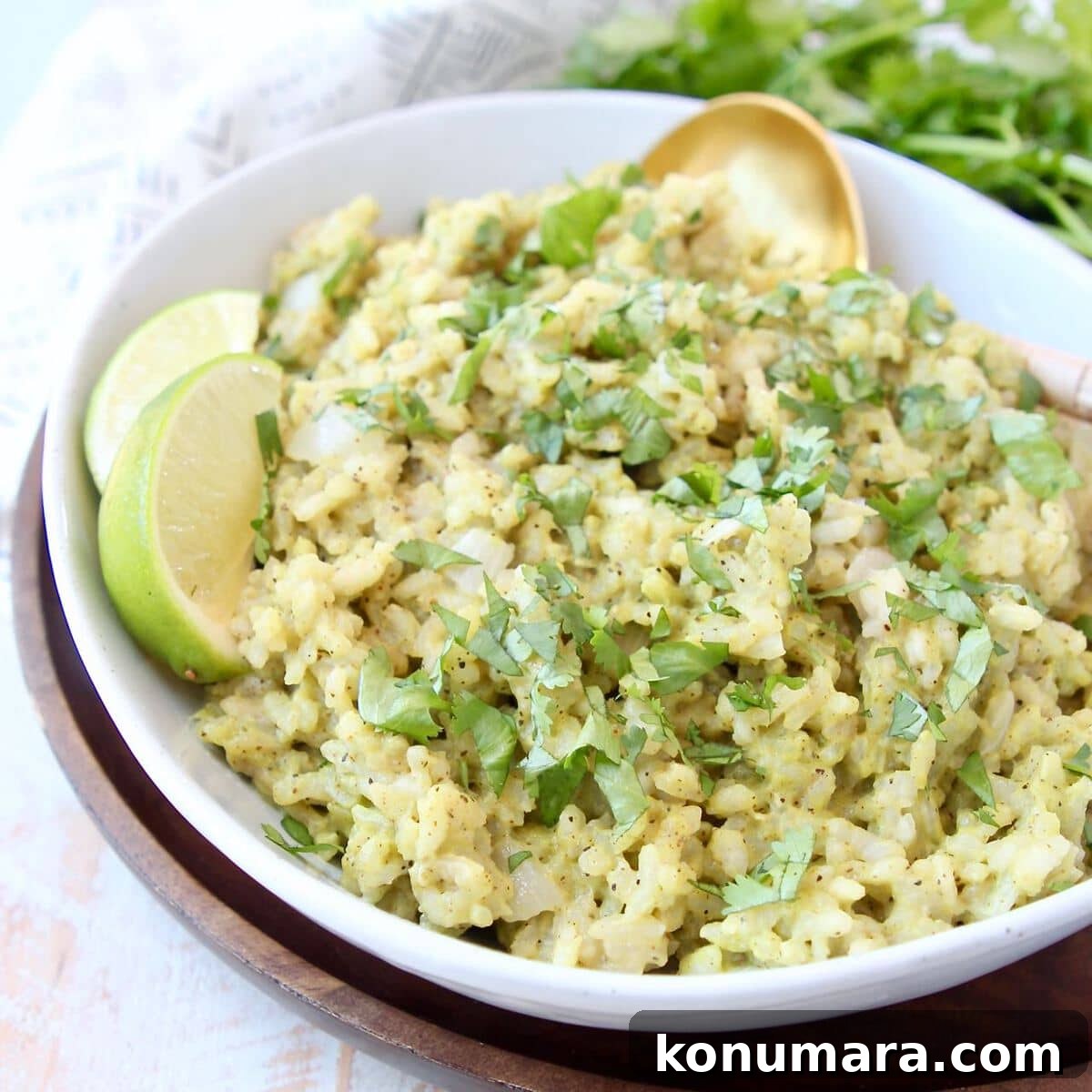 Creamy Cilantro Pesto Risotto Recipe 3 Pesto risotto in bowl with gold spoon and lime wedges