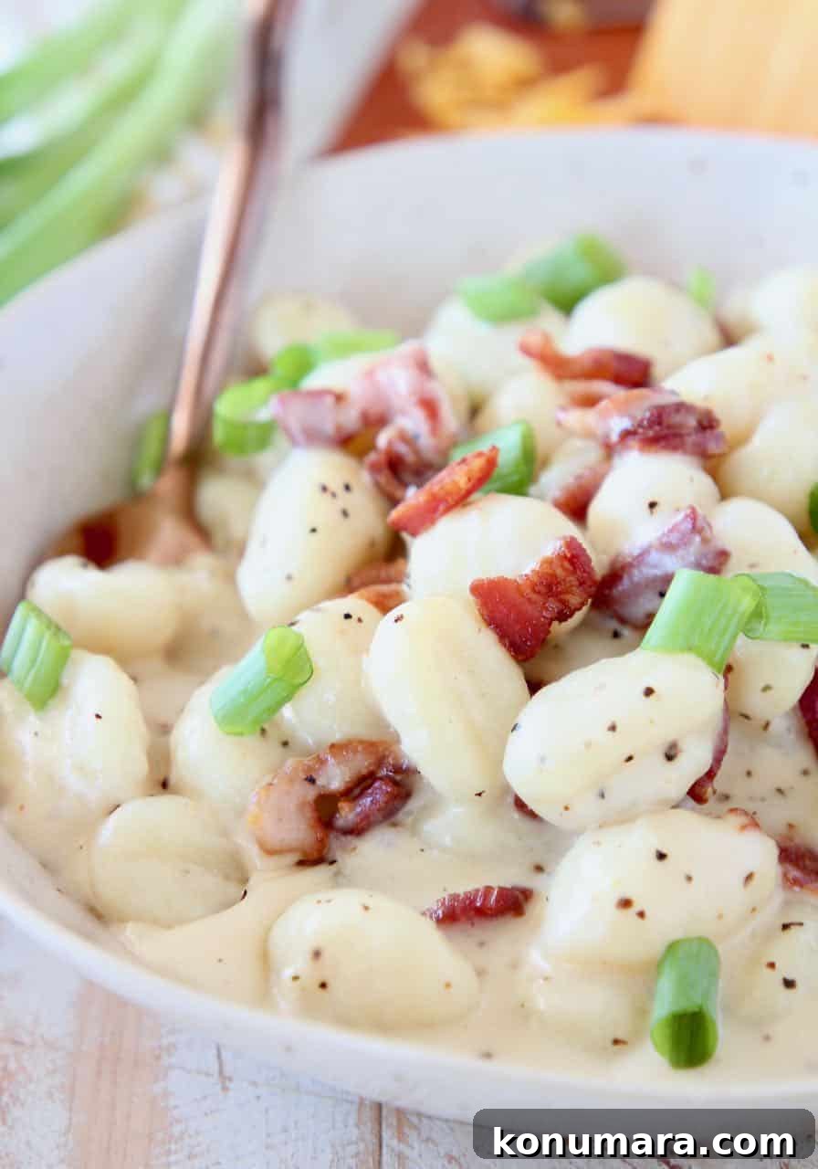 One-Pot Baked Potato Gnocchi Recipe 4 Creamy gnocchi in bowl with spoon