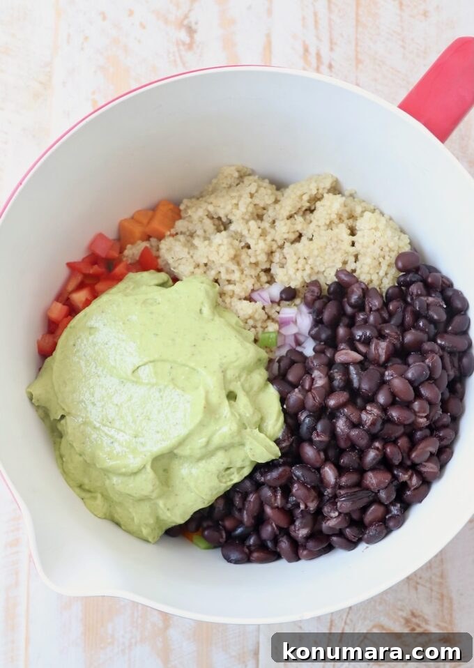 Mexican Sweet Potato Salad with Cilantro Lime Dressing 4 black beans, quinoa and diced vegetables in mixing bowl with avocado salad dressing