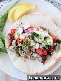 Savory Ground Turkey Gyros with Tzatziki and Pita 5 Greek gyro in pita bread on plate with lemon wedges and fresh mint