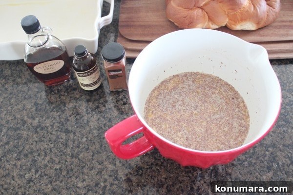 Salted Caramel Praline French Toast Recipe 4 Milk, eggs, and seasonings in a mixing bowl with a pour spout.