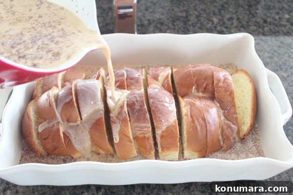 Salted Caramel Praline French Toast Recipe 5 Milk and egg mixture being poured over sliced bread in a casserole dish.