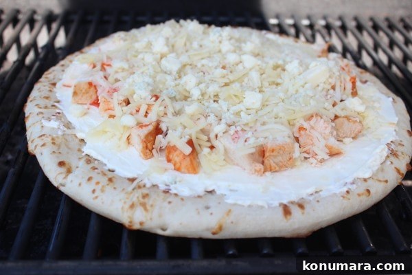 Buffalo Chicken Dip Pizza Recipe 8 Buffalo Chicken Dip Pizza cooking on a grill.