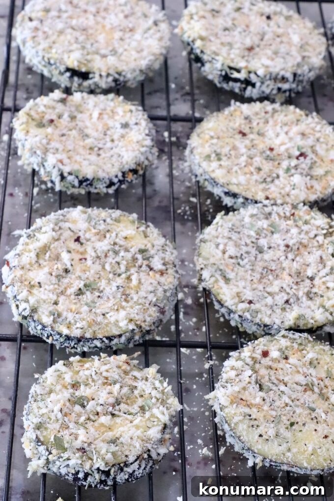 breaded slices of eggplant on a wire rack