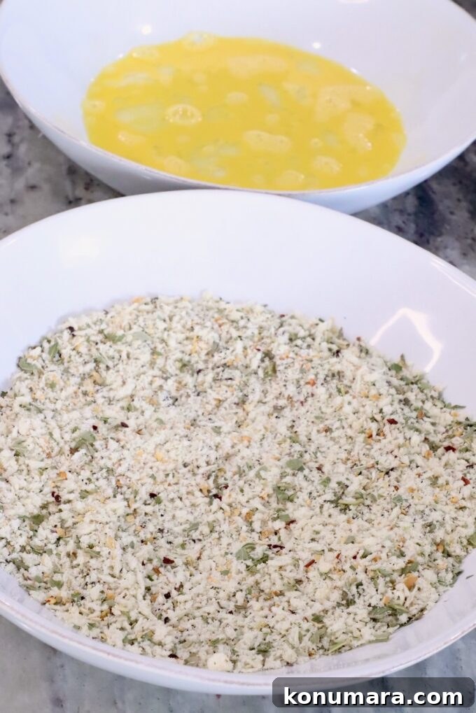 bowl of seasoned breadcrumbs next to a bowl with a whisked egg