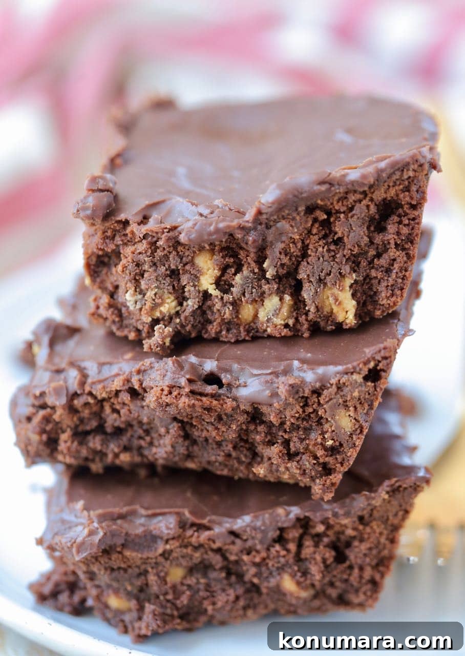 Stack of three double chocolate brownies on plate