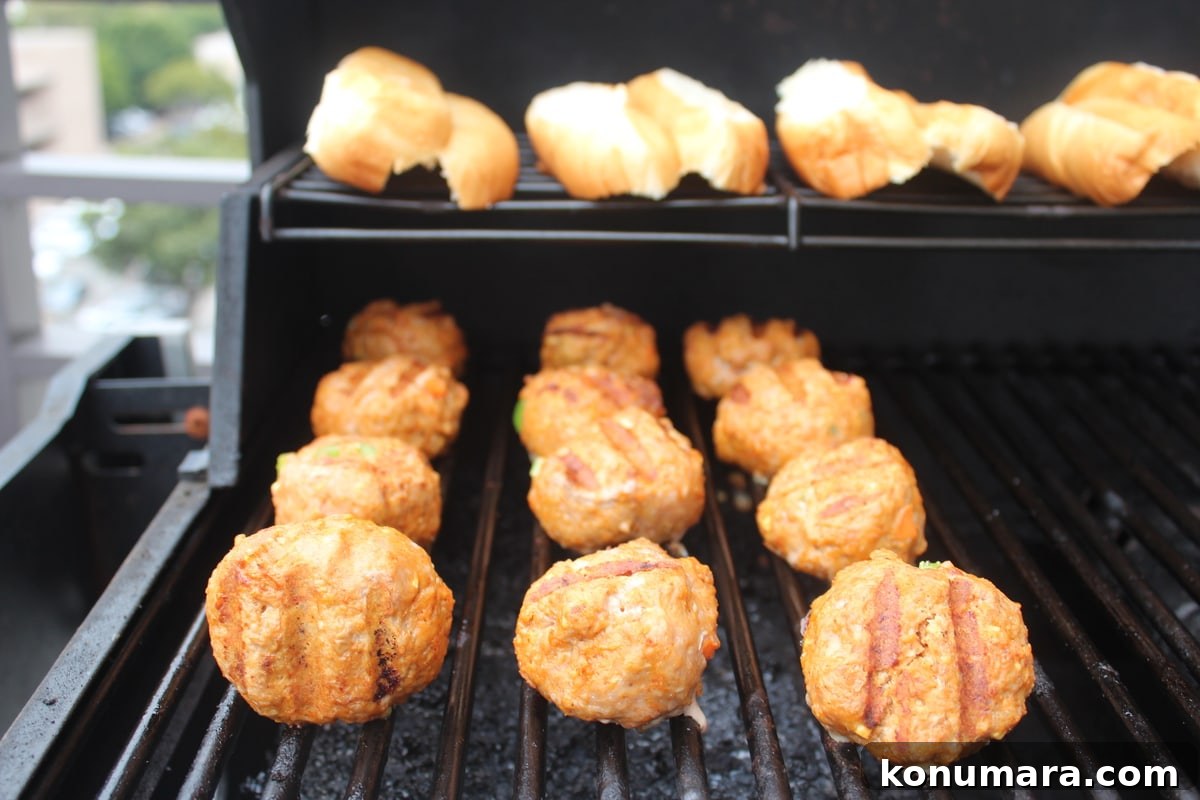 Meatballs and hot dog buns on a grill