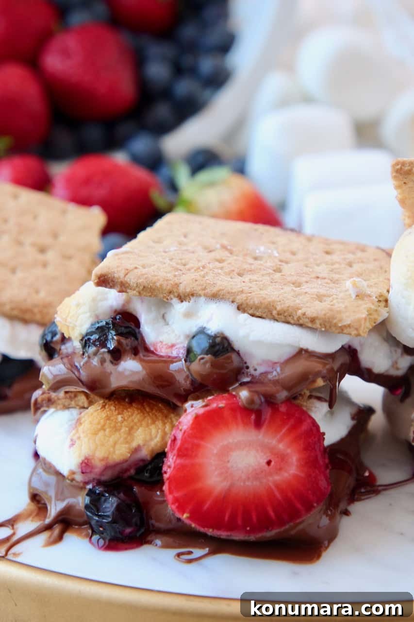 Berry S'mores Recipes: 4 Creative Twists 2 Smores with strawberries and blueberries stacked up on serving platter