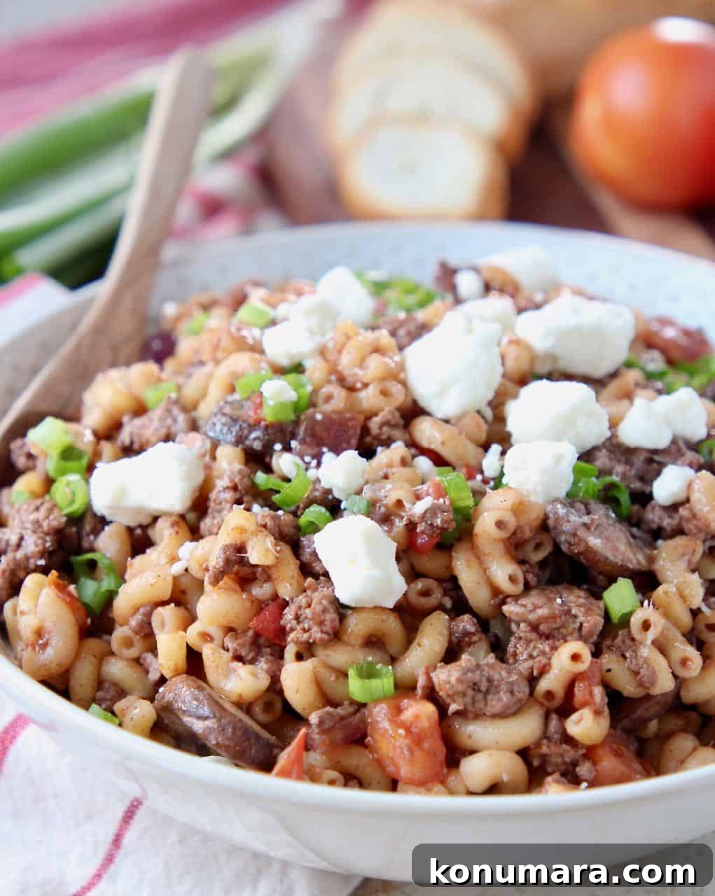 Ground lamb pasta in bowl topped with crumbled feta cheese