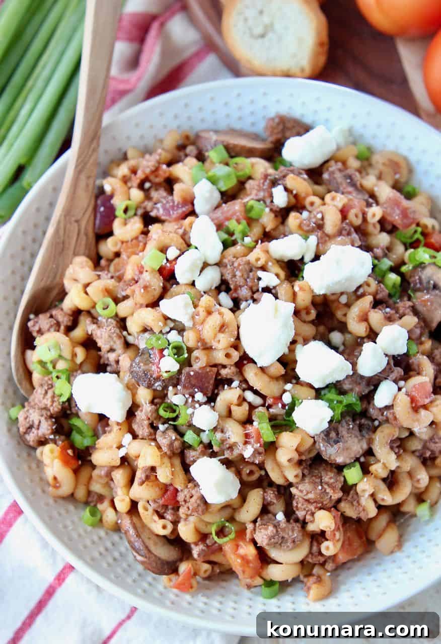 Overhead image of ground lamb pasta topped with feta cheese crumbles