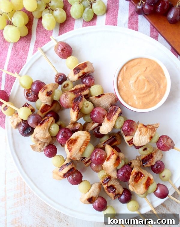 Skewers of marinated chicken & grapes are served with creamy peanut sauce in this Peanut Butter and Jelly Chicken Skewer recipe that's both fun & delicious!