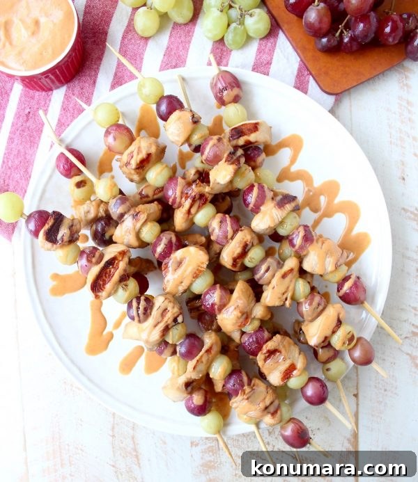 Skewers of marinated chicken & grapes are served with creamy peanut sauce in this Peanut Butter and Jelly Chicken Skewer recipe that's both fun & delicious!