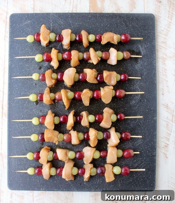 Skewers of marinated chicken & grapes are served with creamy peanut sauce in this Peanut Butter and Jelly Chicken Skewer recipe that's both fun & delicious!
