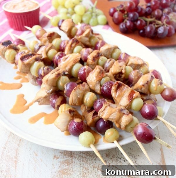 Skewers of marinated chicken & grapes are served with creamy peanut sauce in this Peanut Butter and Jelly Chicken Skewer recipe that's both fun & delicious!