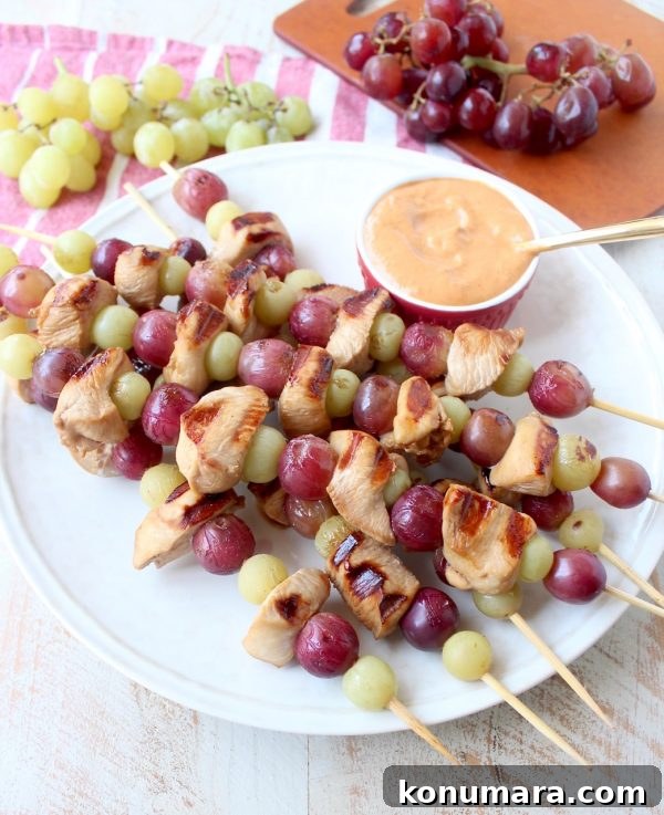 Skewers of marinated chicken & grapes are served with creamy peanut sauce in this Peanut Butter and Jelly Chicken Skewer recipe that's both fun & delicious!