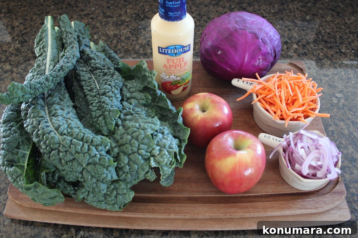 Kale and Apple Slaw Recipe with Lemon Vinaigrette 3 Kale Apple Slaw Ingredients on a wood board