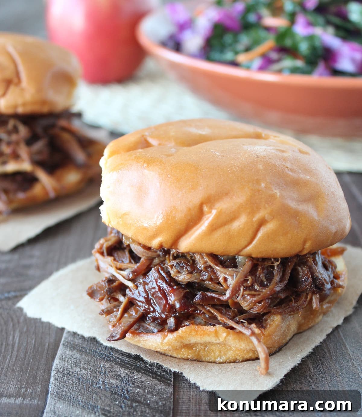 Slow-Cooked BBQ Brisket Sandwich with Smoky Sauce 2 shredded bbq brisket in between toasted hamburger buns
