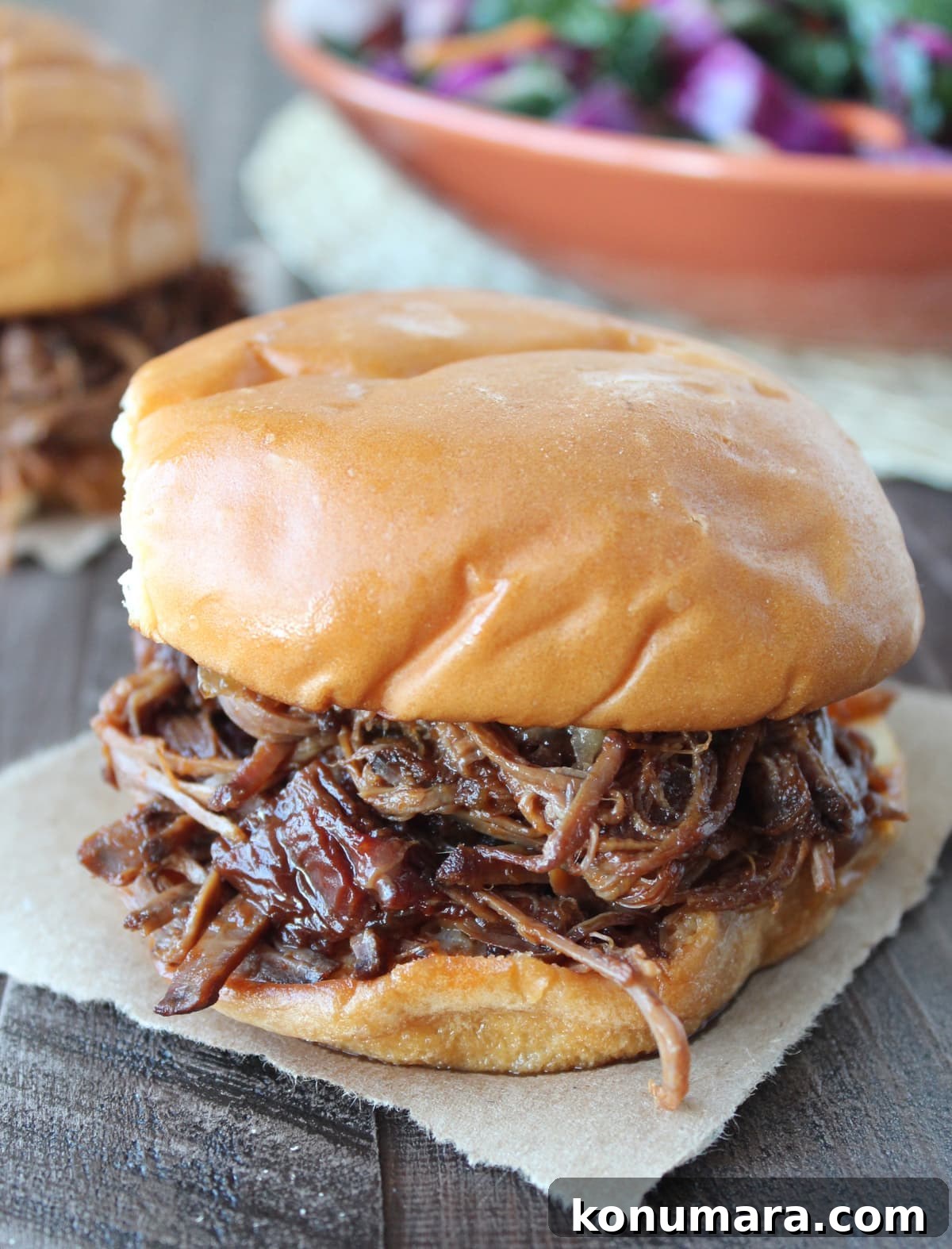 Slow-Cooked BBQ Brisket Sandwich with Smoky Sauce 11 shredded bbq brisket in between two hamburger buns
