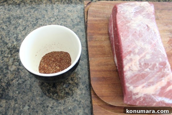 Slow-Cooked BBQ Brisket Sandwich with Smoky Sauce 5 uncooked brisket on wood board, sitting next to a bowl of mixed spices