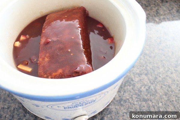Slow-Cooked BBQ Brisket Sandwich with Smoky Sauce 8 brisket in a crock pot covered in bbq sauce