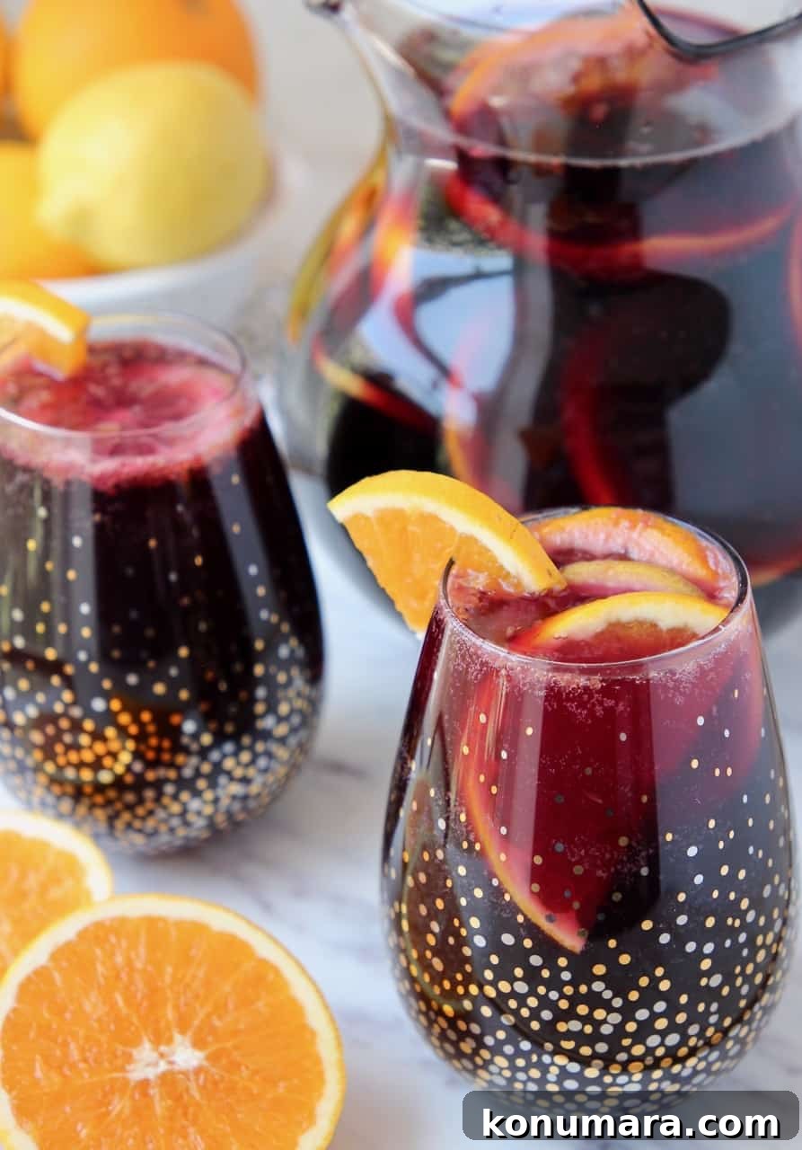 How to Make Classic Red Sangria with Citrus and Berries 2 Red sangria in glasses and pitcher