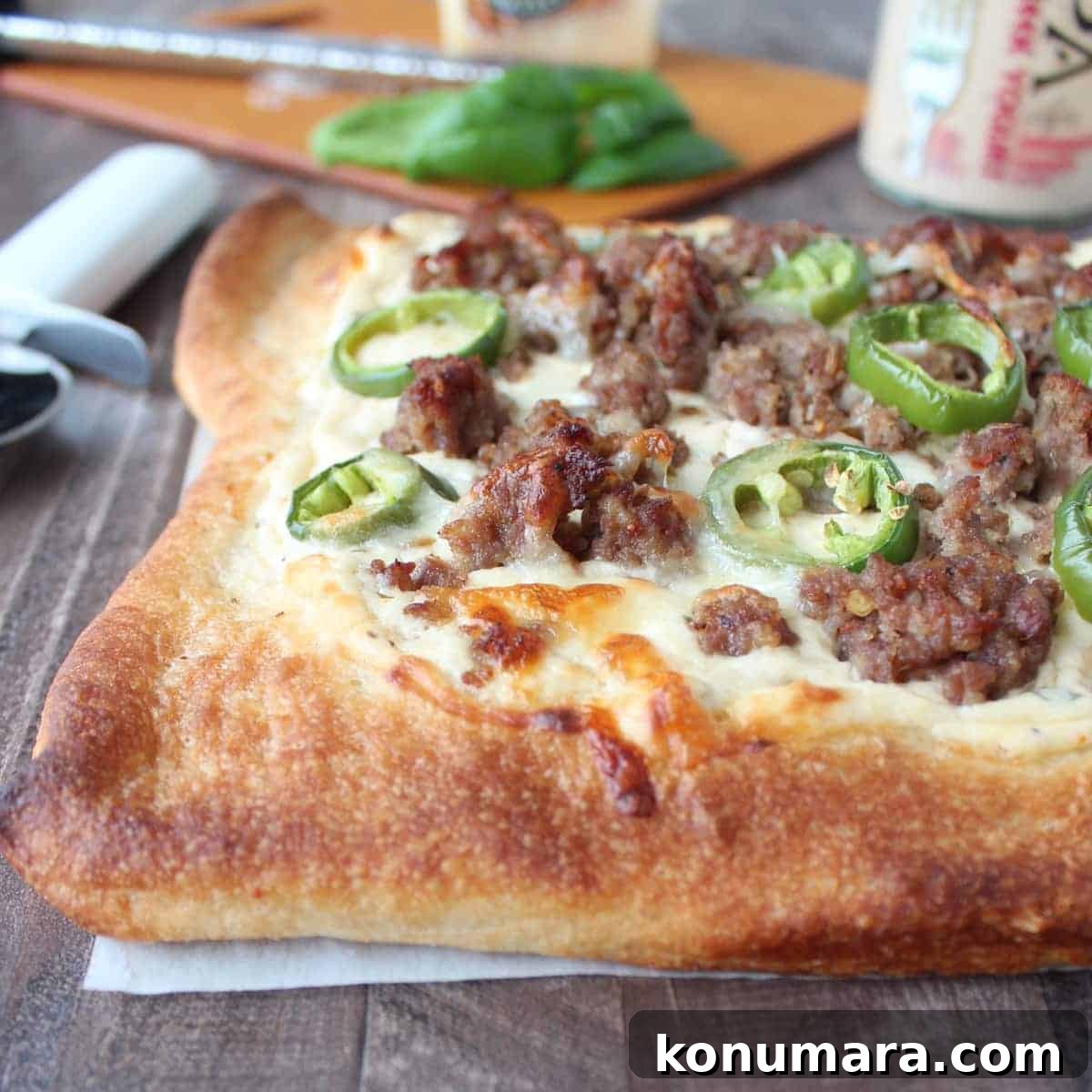 baked pizza topped with Italian sausage crumbles and sliced jalapenos