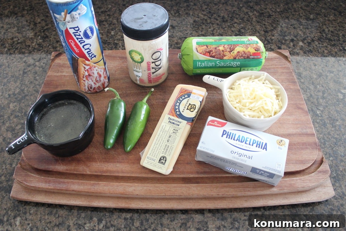 ingredients for spicy sausage pizza on a wood board