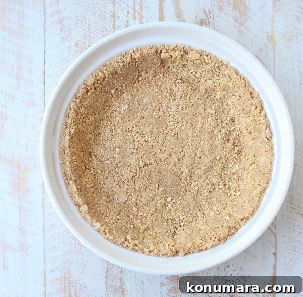 graham cracker crust in a white pie plate