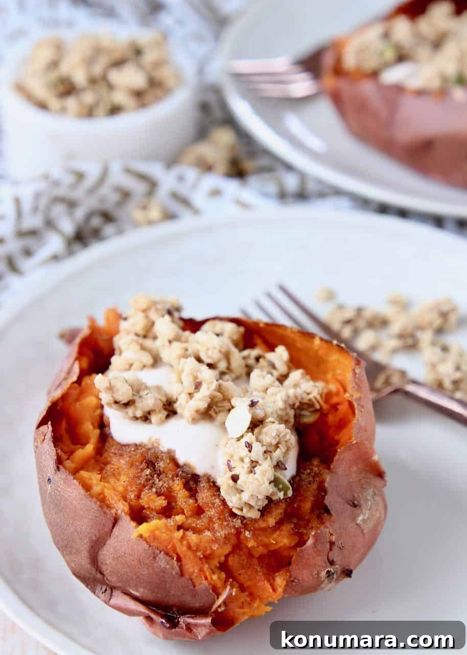 Roasted sweet potato on plate filled with yogurt and granola