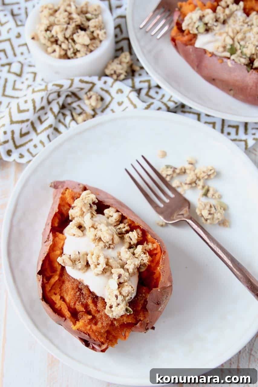 Roasted sweet potato sliced open and filled with yogurt and granola