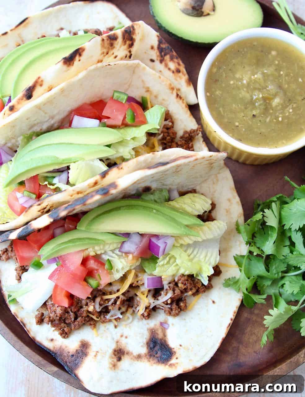 Trader Joe's Tacos: What to Buy, Reviews and Taco Recipes 3 Tacos on wood tray with ramekin of salsa on the side