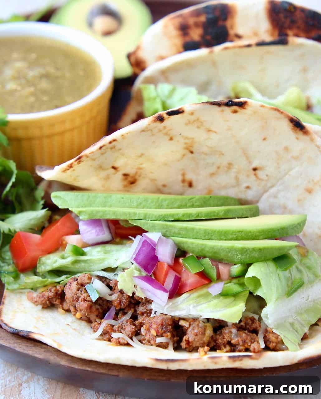 Trader Joe's Tacos: What to Buy, Reviews and Taco Recipes 5 Ground beef taco in flour tortilla topped with sliced avocado