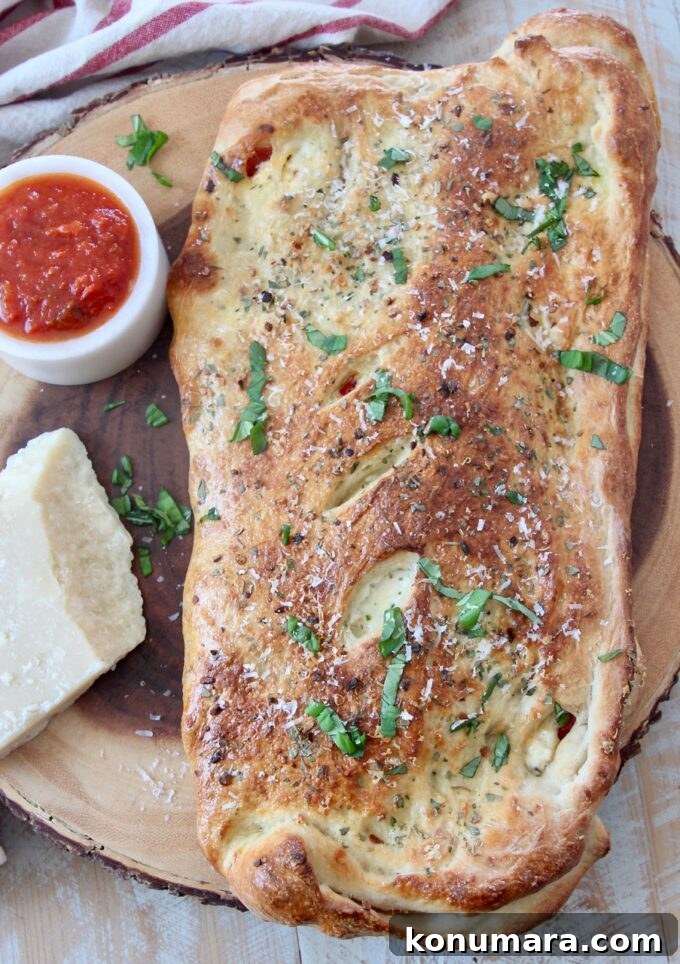 Authentic Italian Calzone Recipe 4 baked calzone on wood serving board