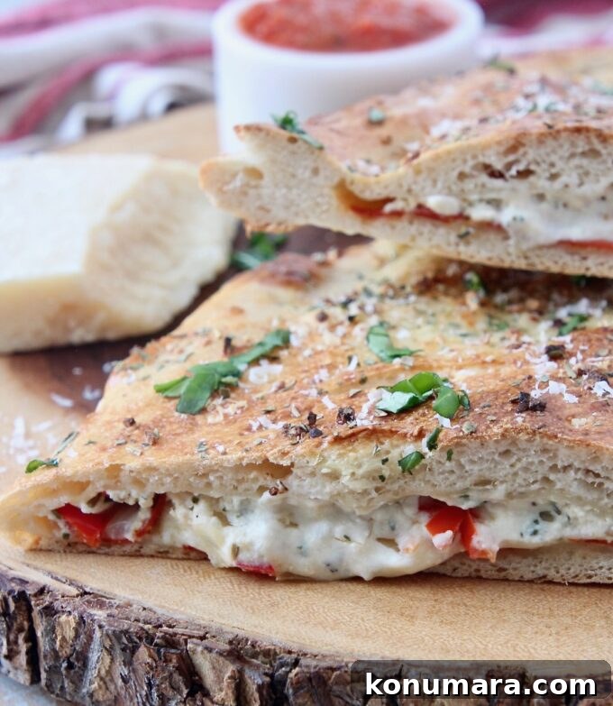 Authentic Italian Calzone Recipe 5 calzone cut in half on wood cutting board