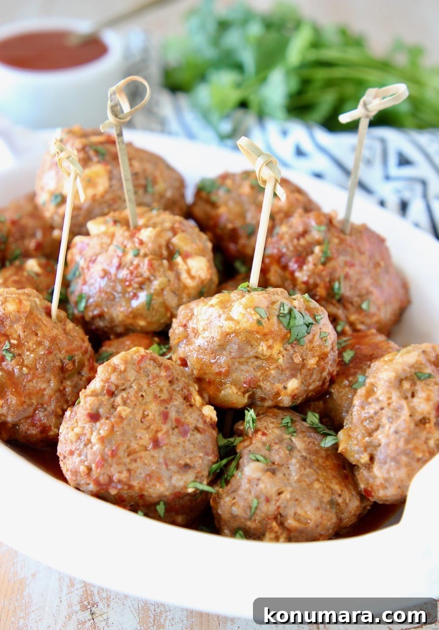 Taco meatballs in bowl with small wooden skewers with fresh cilantro
